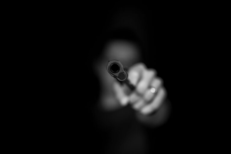 man holding gun in black screen