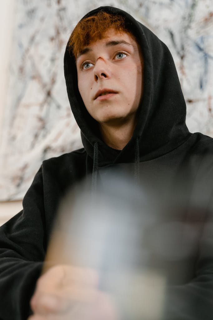 A Man in Black Hoodie with Bruise on Nose