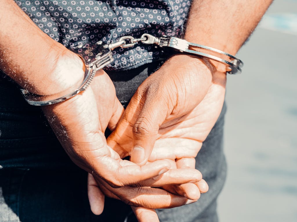 Close Up Photography of Person in Handcuffs