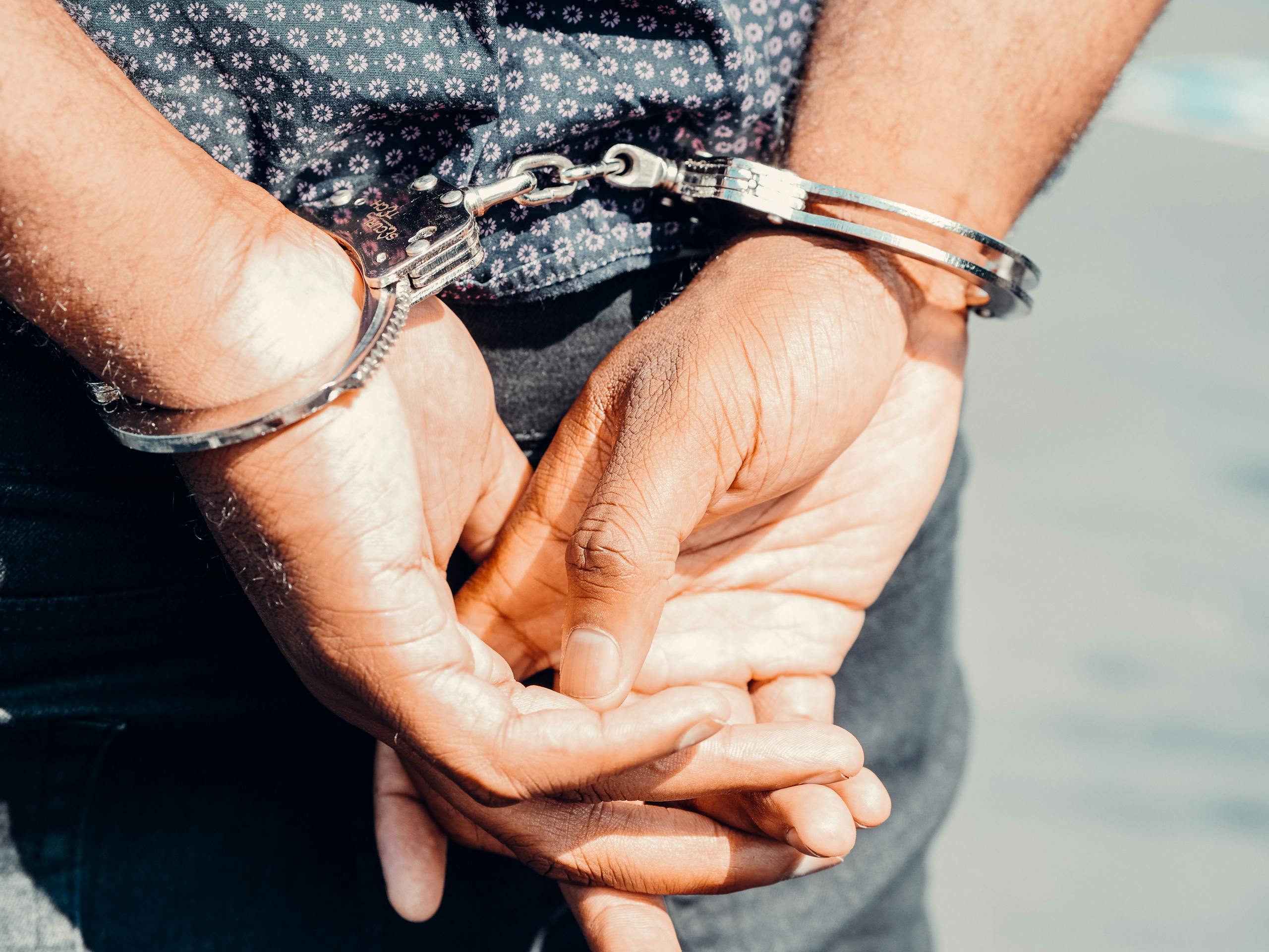 Close Up Photography of Person in Handcuffs