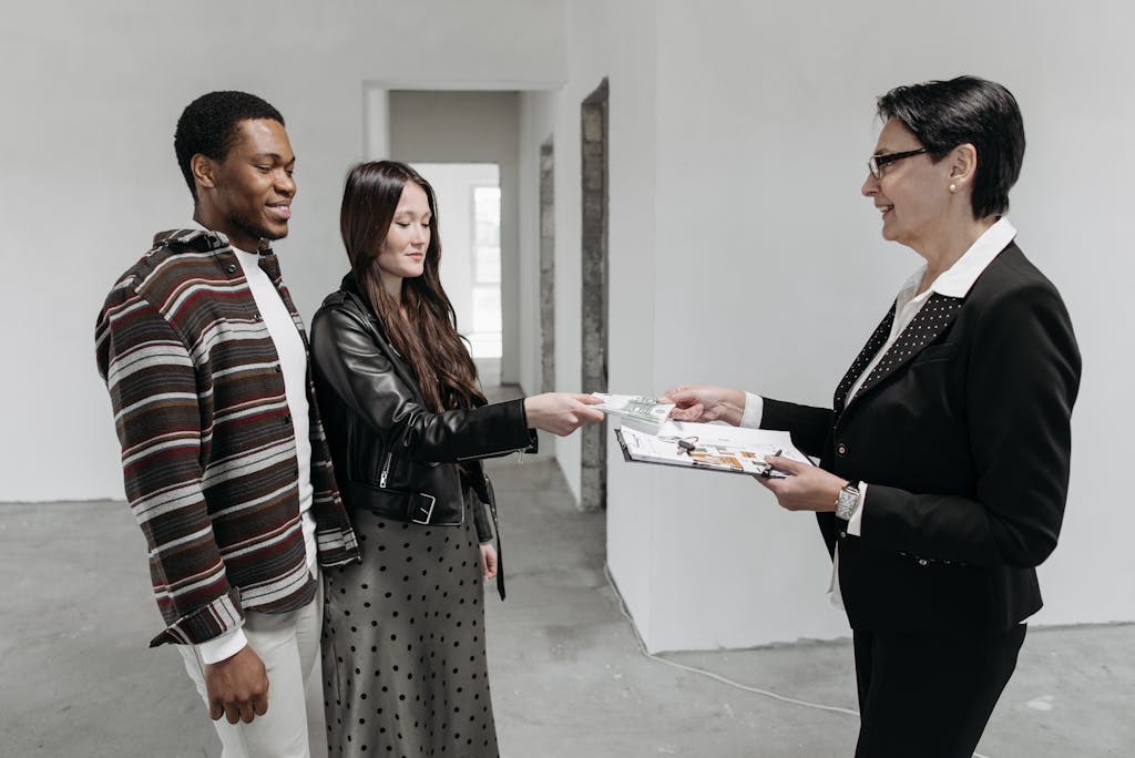 Real Estate Agent Showing House Plans to Couple