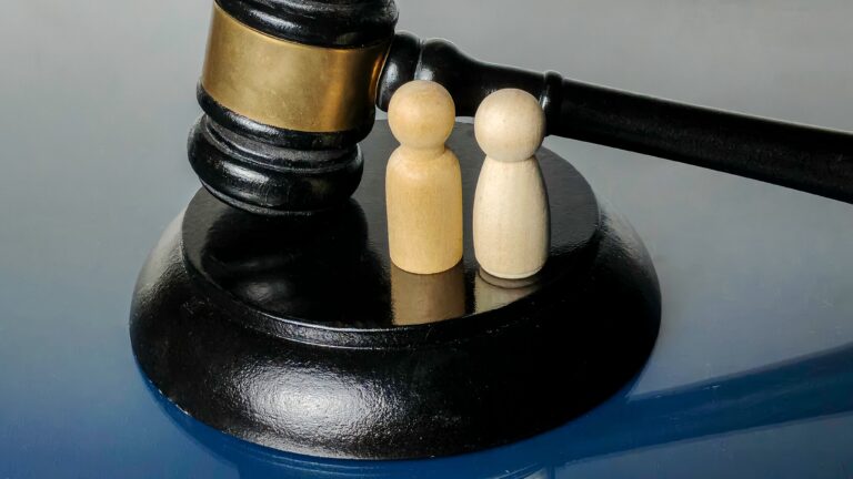 Two,Wooden,Peg,People,Figurines,On,Gavel,Base,Representing,Couple,
